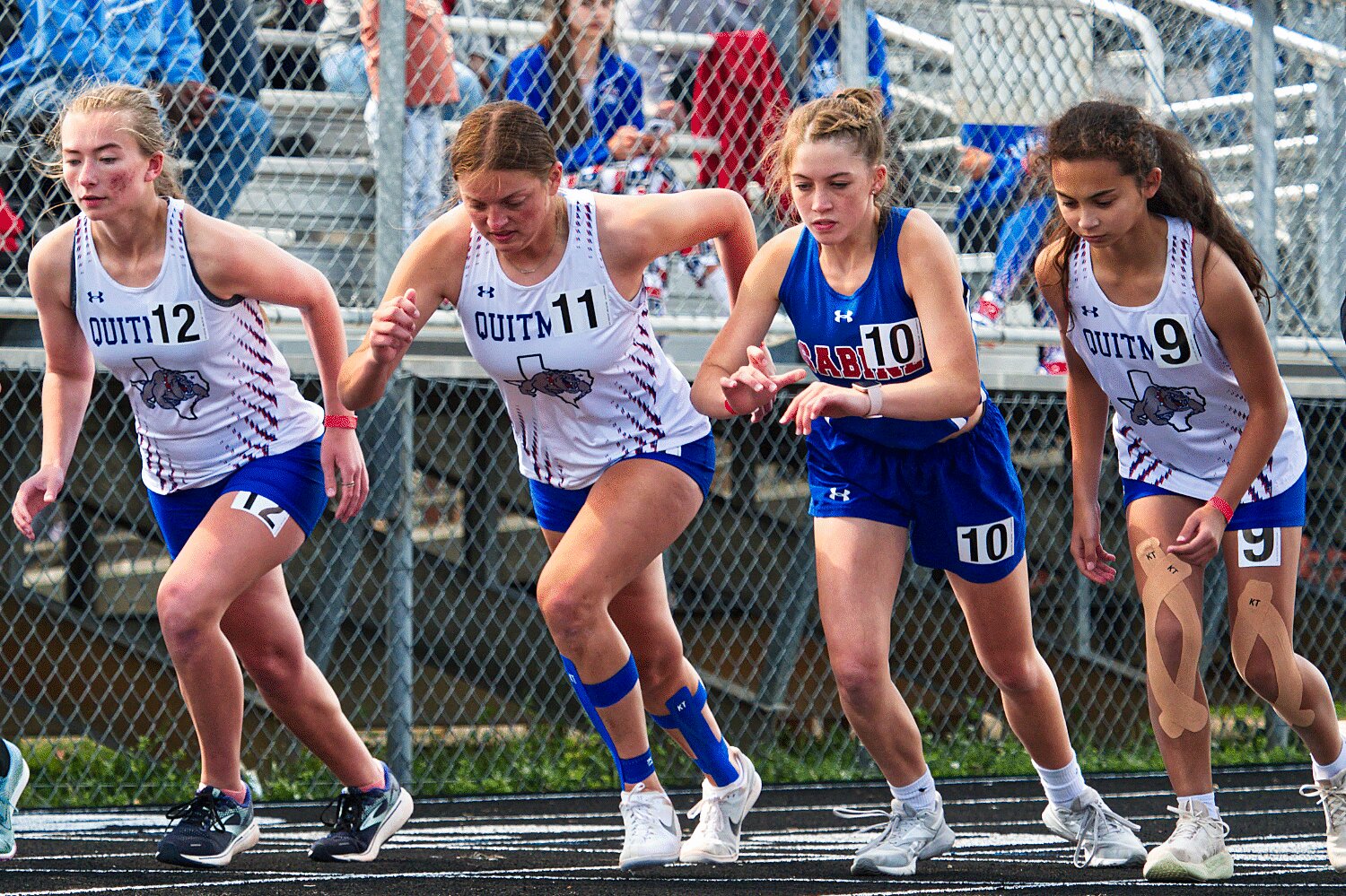 In white, left to right, Quitman runners McKenna Wood, Madison Pence and Katie De Gorostiza start their 1600m competition Saturday. [more prelims and finals photos]